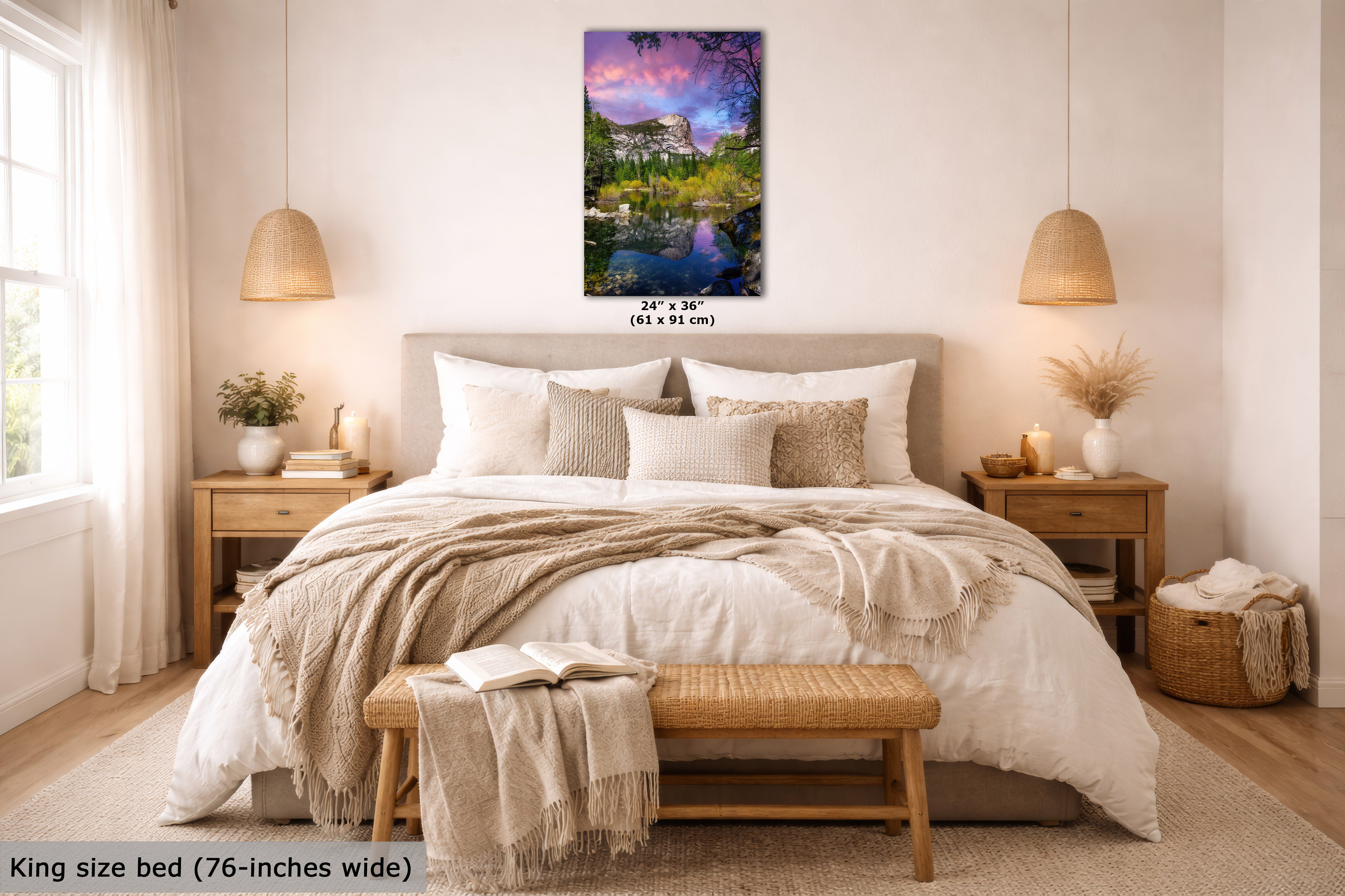 A bedroom scene showing a framed vertical landscape wall art piece above a neatly made bed. The artwork depicts a colorful mountain lake landscape with purple, blue, green, and pink tones.