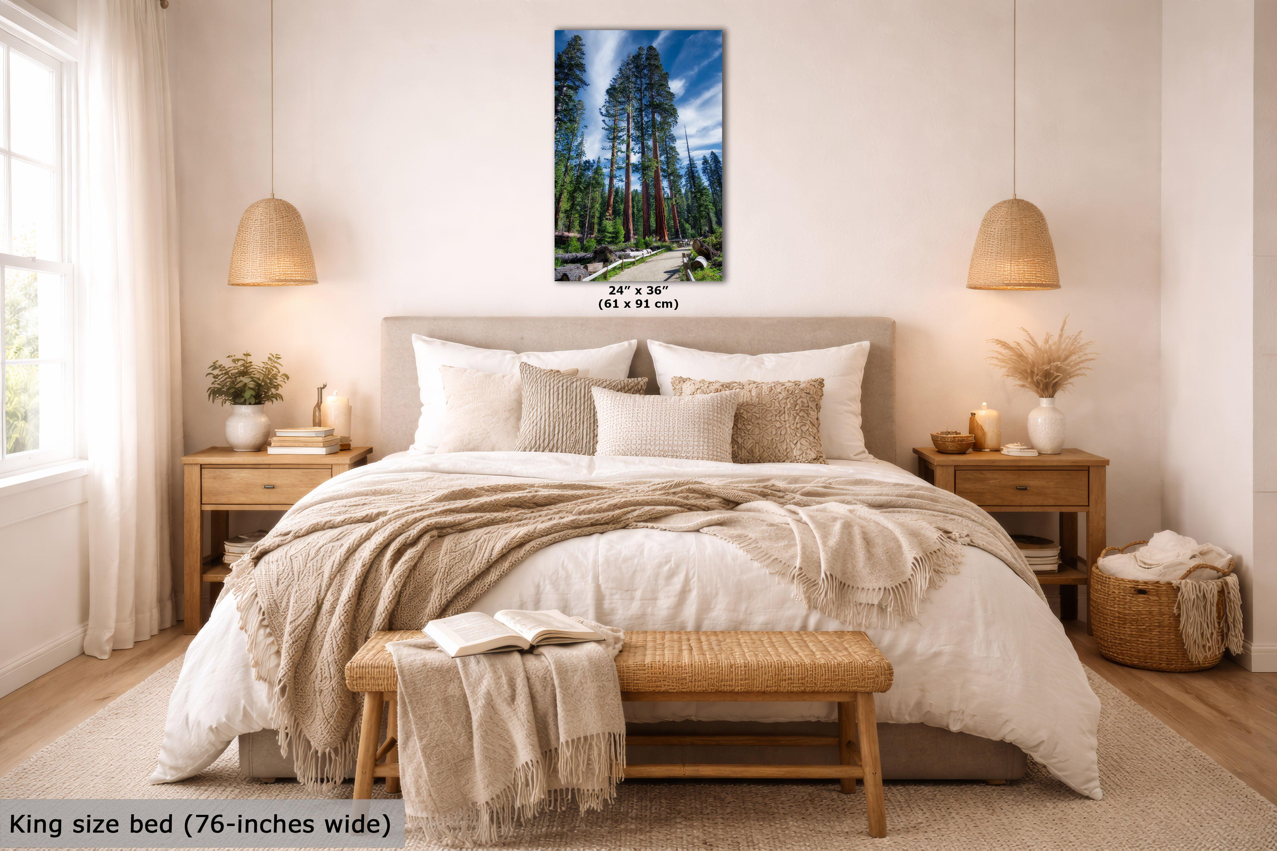 A framed vertical wall art print showing a forest landscape with tall trees and a blue sky, displayed above a neatly made bed in a bright, modern bedroom. The print includes size text reading 24 x 36 inches, and the room scene includes a text overlay noting the king size bed is 76-inches wide.