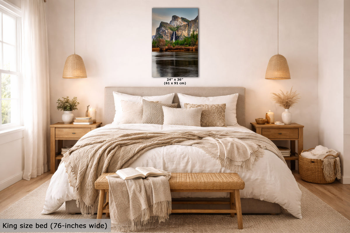 A framed wall art print showing a mountain landscape with waterfalls is displayed above a neatly made bed in a bright, modern bedroom. The print includes size text reading 24 x 36 inches, and the room scene includes a text overlay noting the king size bed is 76 inches wide.