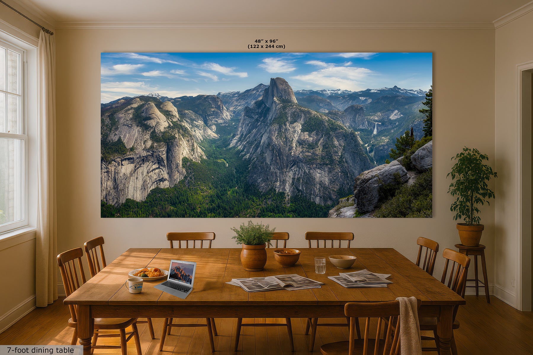 A large wall art print showing a Yosemite landscape with Half Dome and blue sky, displayed above a wooden dining table in a styled dining room. The print includes size text at the top reading 48x96 inches.