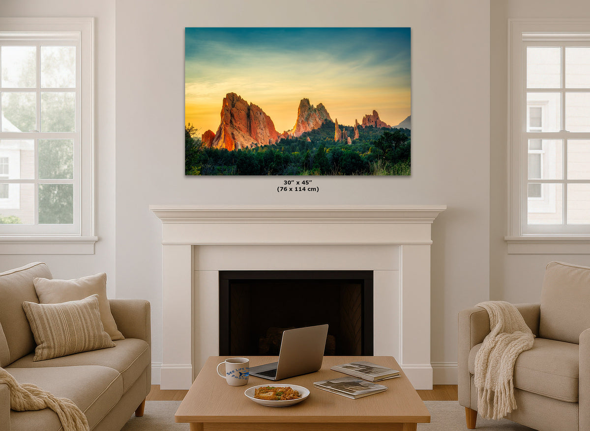 A wall art print showing a desert rock landscape at sunset hangs above a white fireplace in a bright living room. Small text below the print reads 30 x 45 in (76 x 114 cm).
