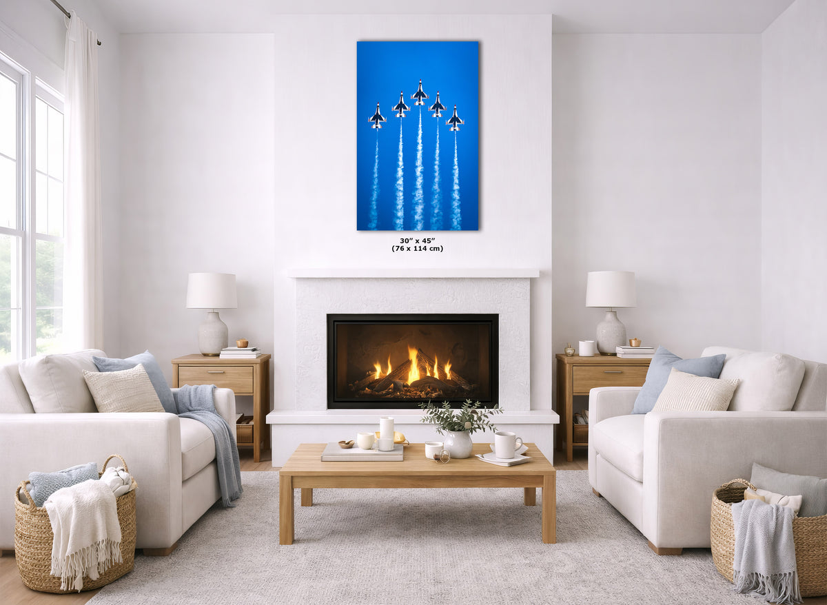 A canvas wall art print depicting an Thunderbird Air Force formation with jet trails, displayed in a modern living room mockup above a fireplace.