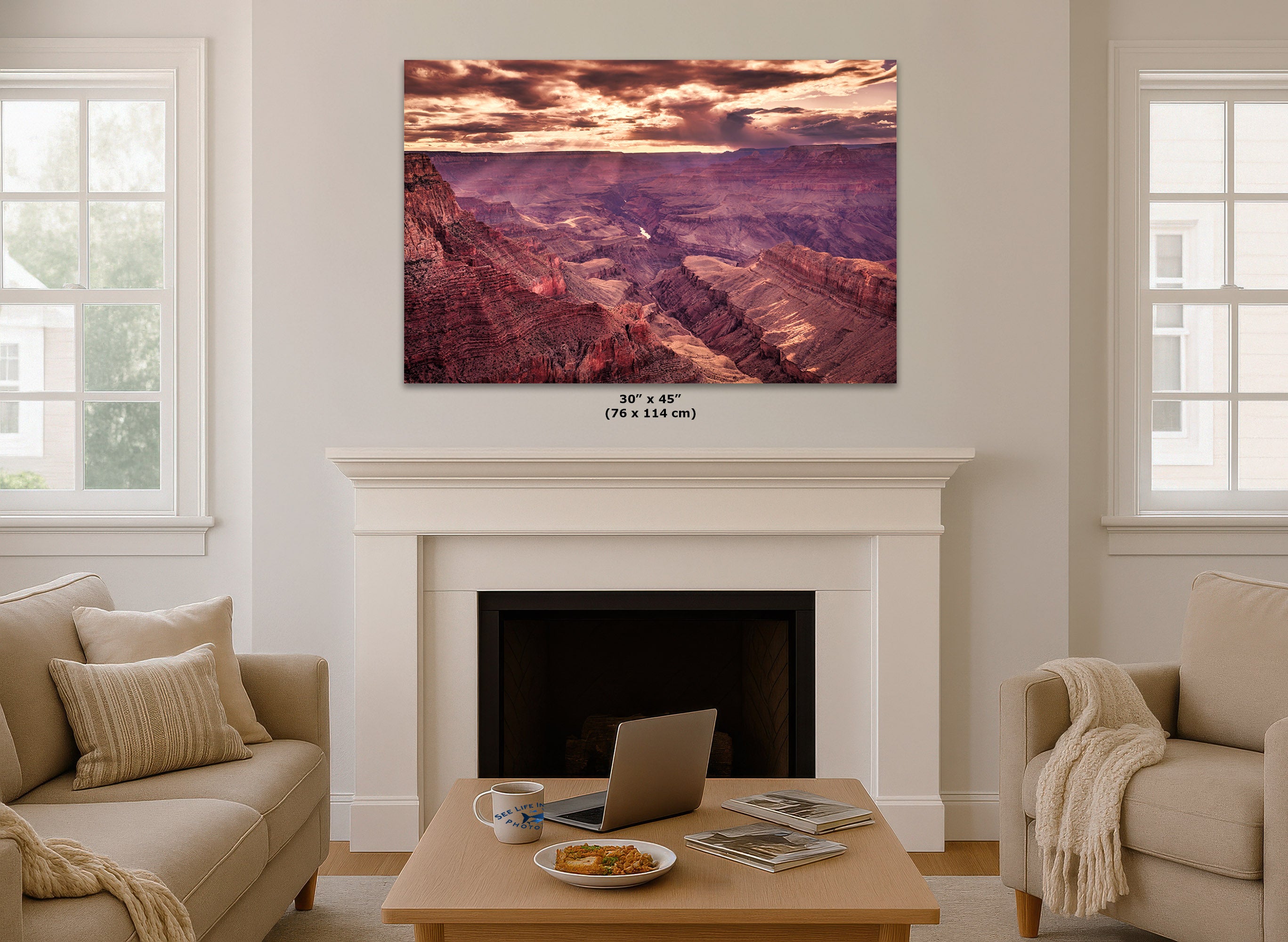 Living room with a large wall-mounted canvas of the Grand Canyon above a fireplace.