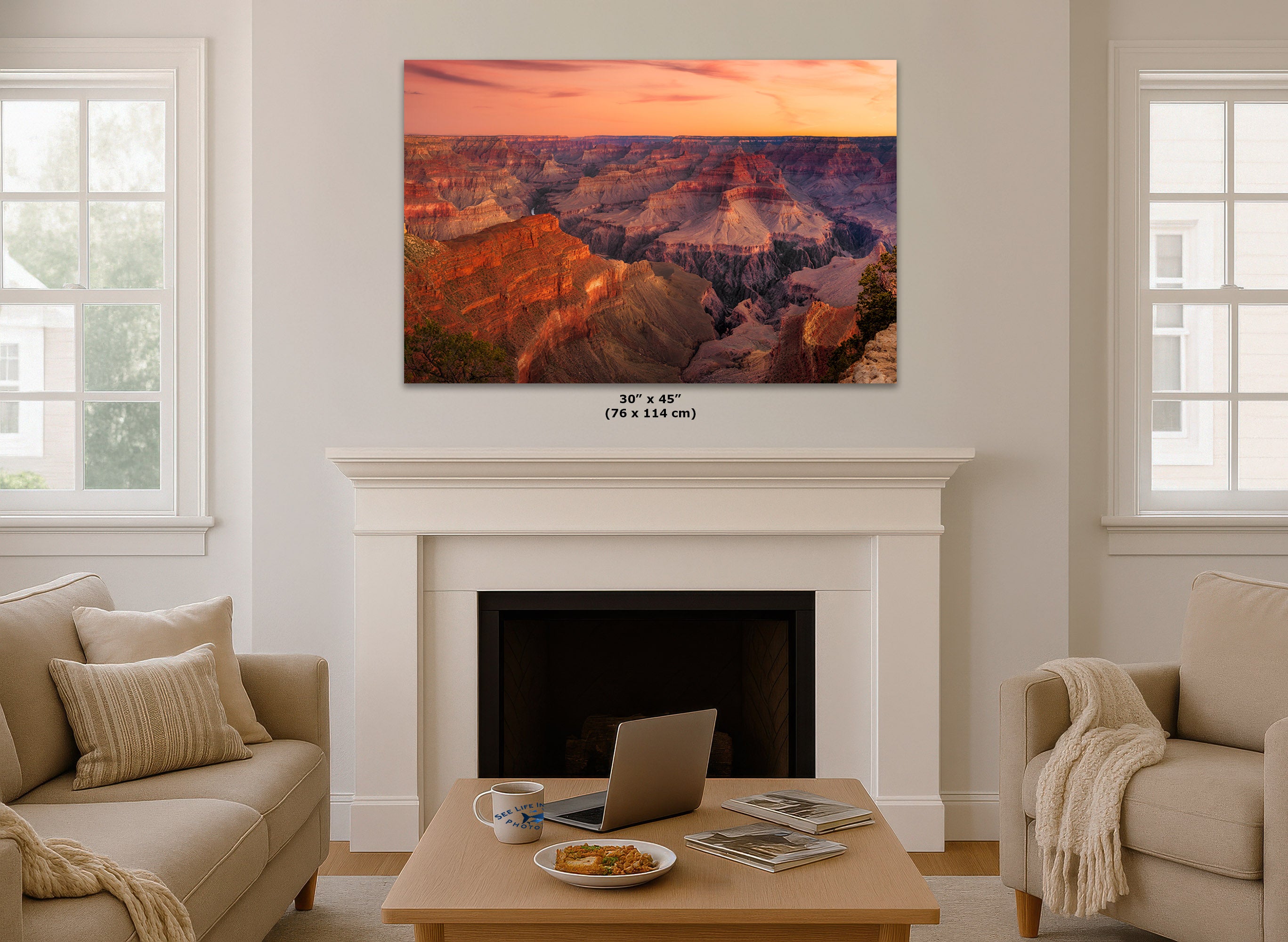 A large wall art print depicting the Grand Canyon at sunset, displayed in a mockup living room setting above a white fireplace mantel.
