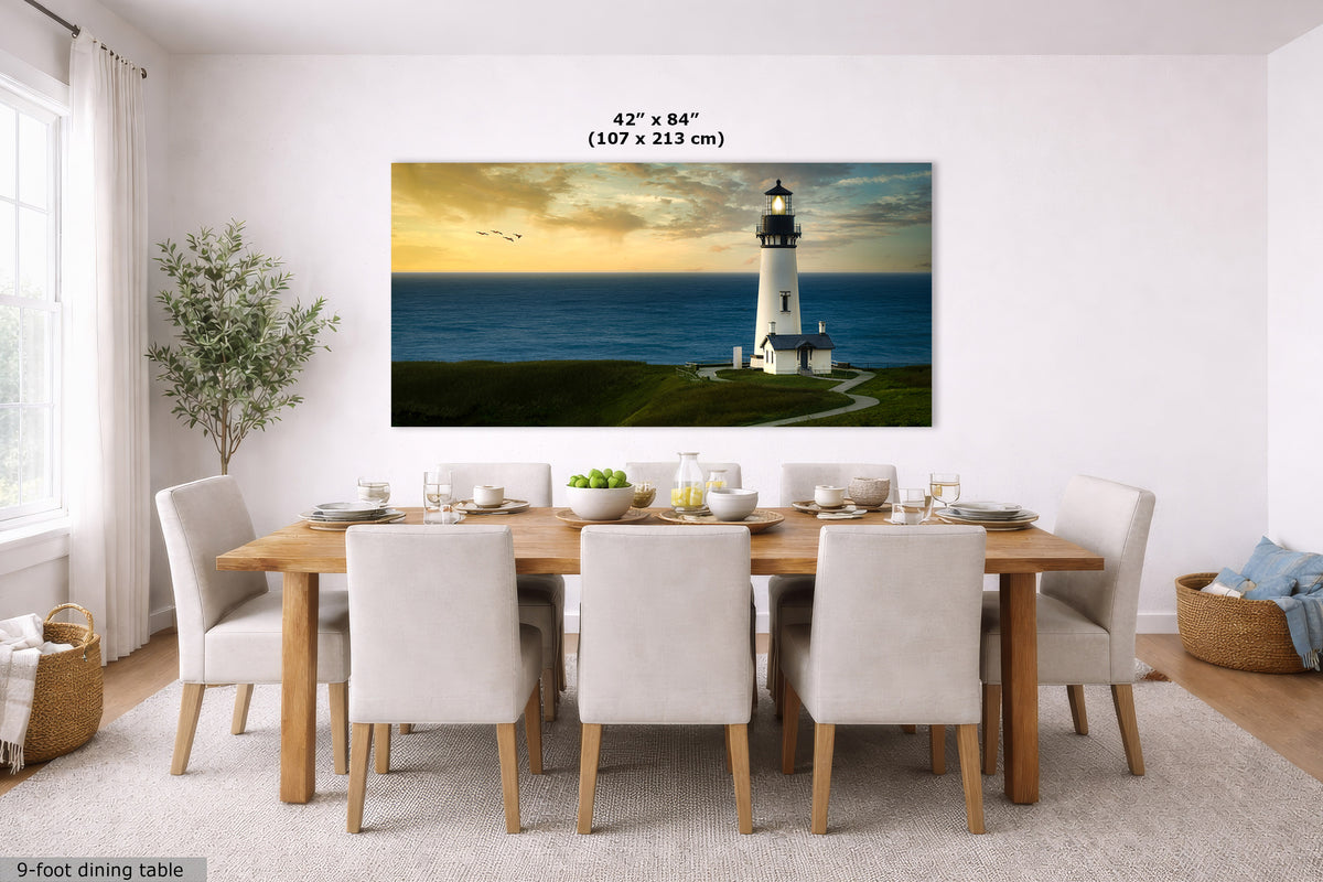 A large rectangular wall art print showing a lighthouse by the ocean, displayed above a dining table in a bright modern room. The print includes size text reading 42 x 84 inches (107 x 213 cm) and a small label in the corner saying 9-foot dining table.