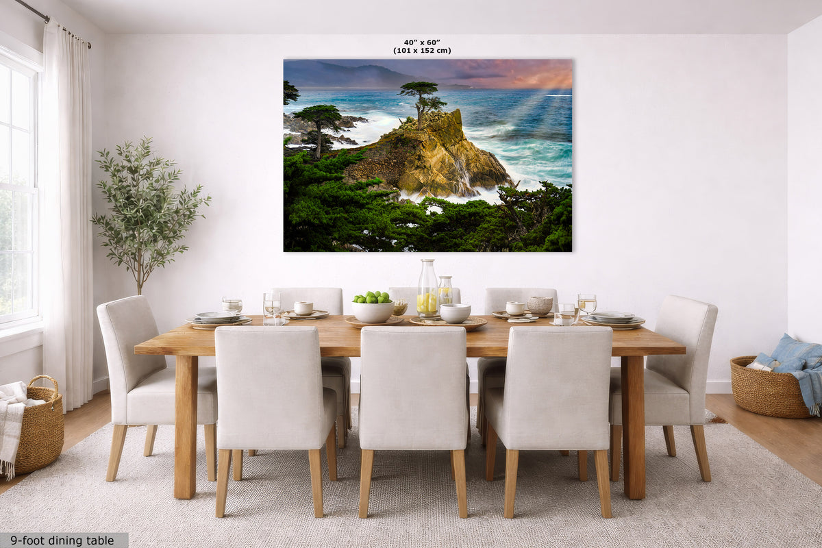 A large square wall art print showing a coastal cliff with green trees, blue ocean waves, and a rainbow, displayed above a dining table in a bright modern room. Small text at the top reads 40" x 60".