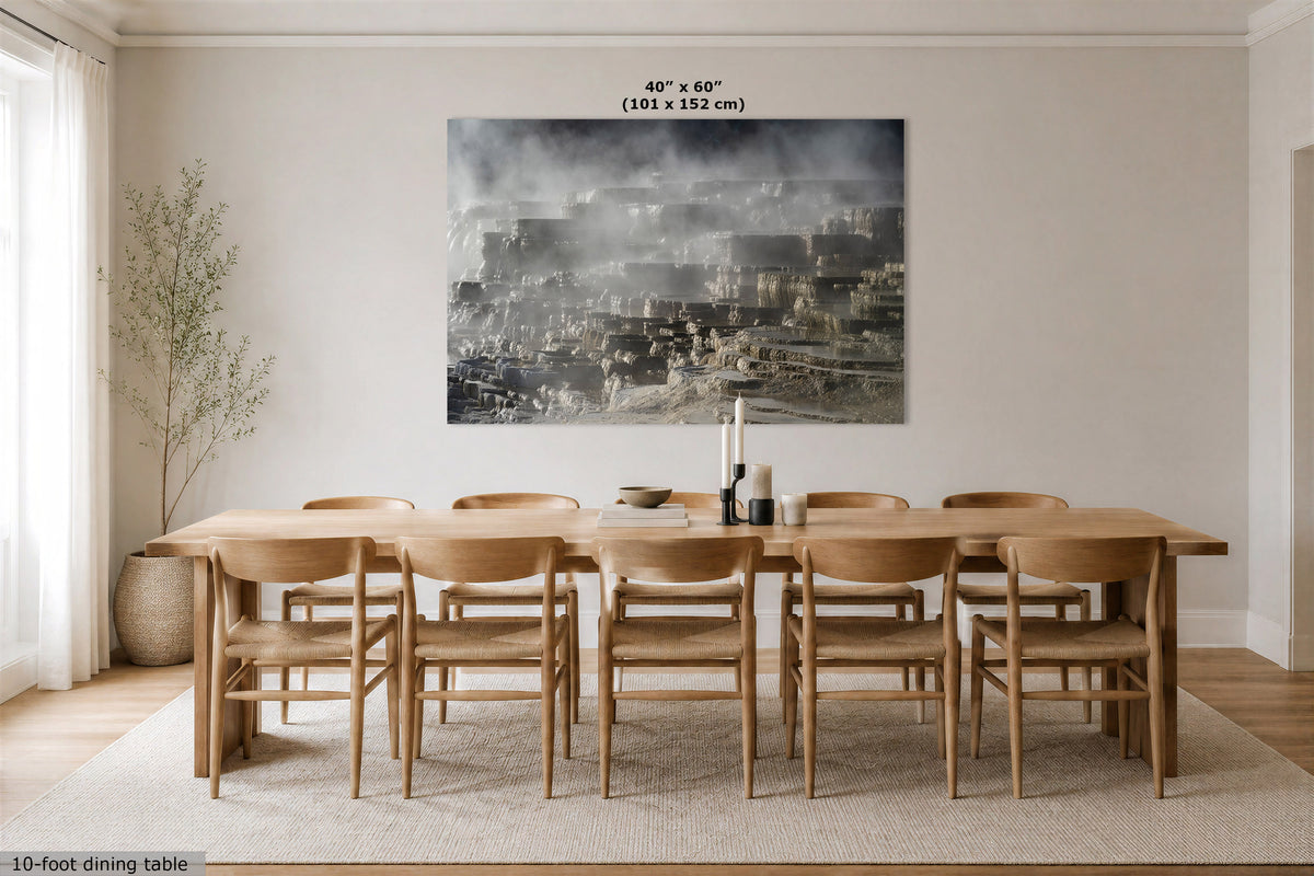 A large rectangular wall art print depicting a misty cityscape in grayscale tones, displayed above a wooden dining table and chairs in a bright, modern dining room. The print has text at the top reading '40" x 60" (101 x 152 cm)' and text at the bottom left reading '10-ft dining table'.