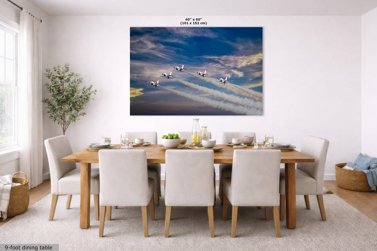 A large rectangular wall art print showing five airplanes flying across a dramatic blue sky with white contrails, displayed above a wooden dining table with white chairs in a bright modern dining room. Small text at the top reads 40" x 60" and text at the bottom left reads 9-foot dining table.