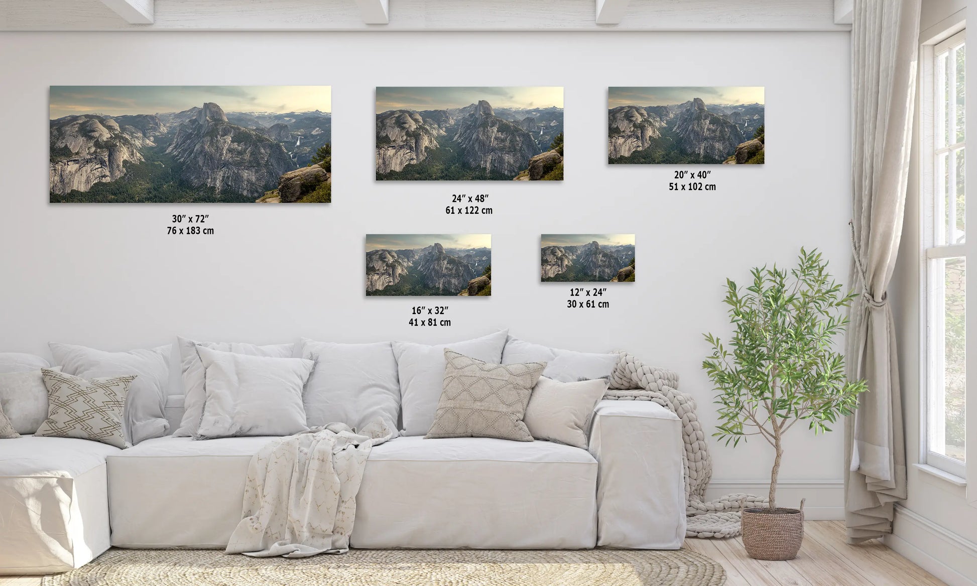 a living room with a white couch and four pictures on the wall