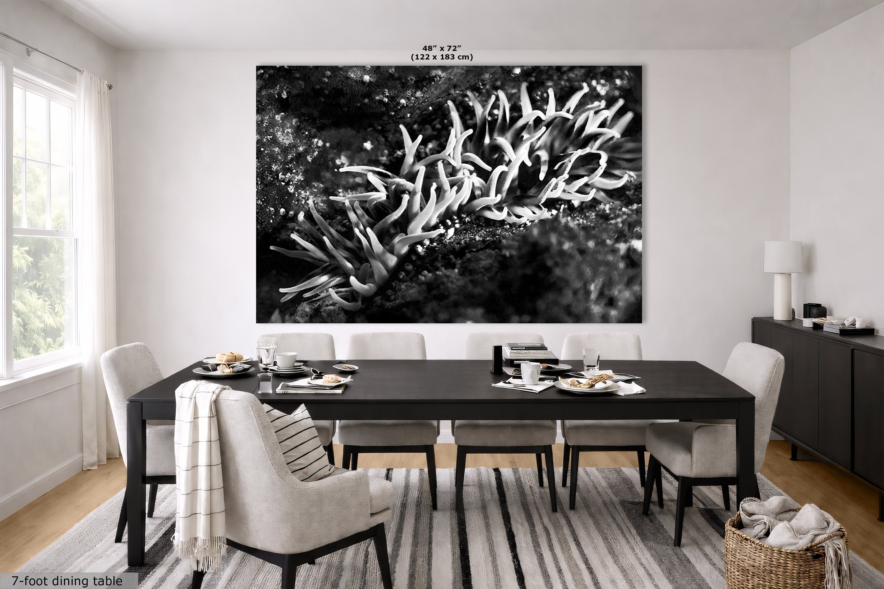A large black and white wall art print depicting coral or branching organic forms, displayed above a dining table in a bright modern dining room. The print has small size text at the top reading 48" x 72" (122 x 183 cm).