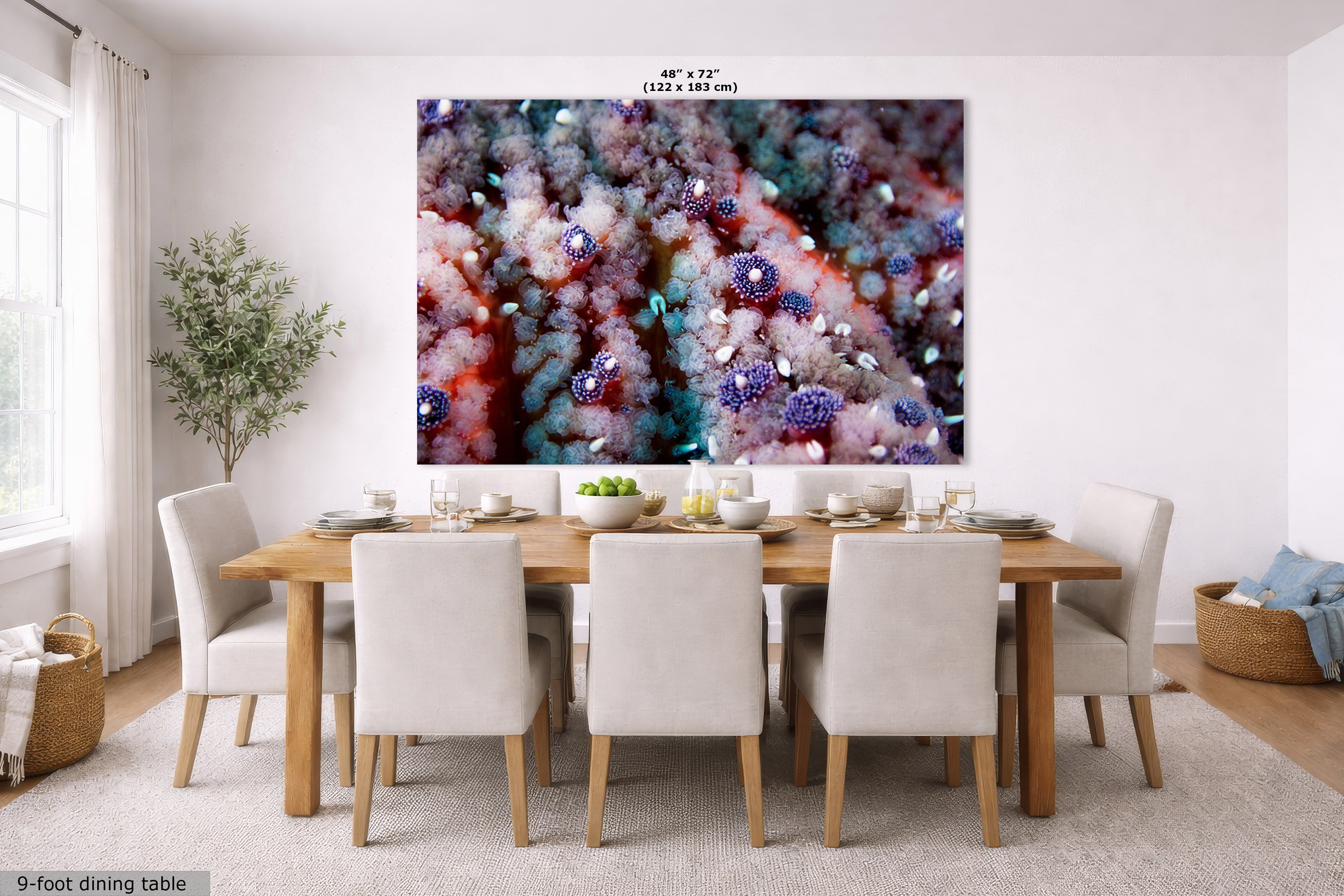 A large wall art print depicting a close-up of a starfish that is purple, blue, and white, displayed in a modern dining room setting above a wooden dining table and chairs.