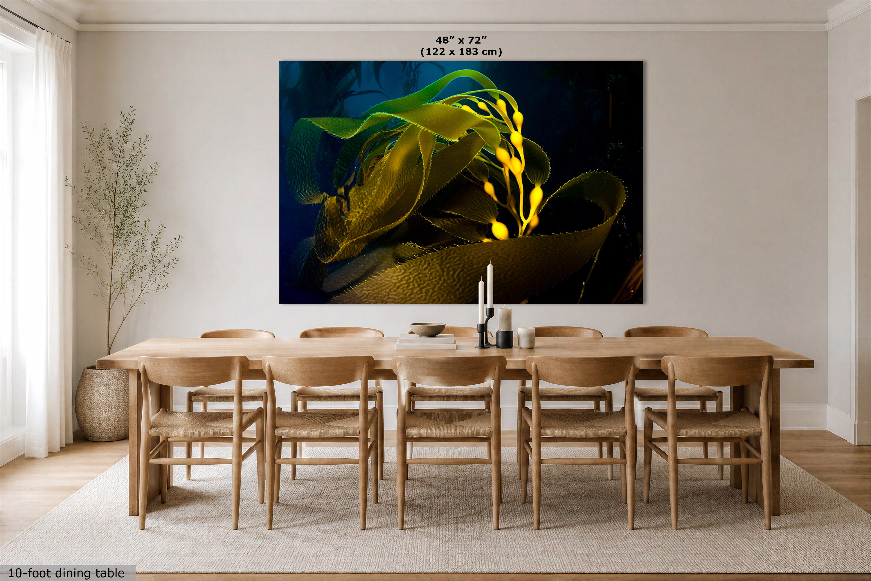 A large rectangular wall art print showing a close-up underwater scene with green seaweed, displayed above a wooden dining table and chairs in a bright dining room. Text at the top reads 48" x 72" (122 x 183 cm).