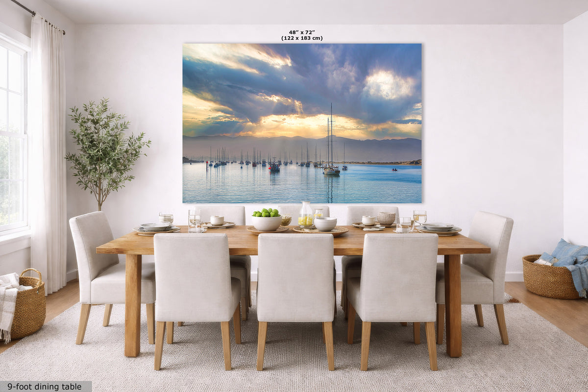 A large wall mural or canvas print depicting a scenic sunrise over a harbor filled with sailboats, displayed on a dining room wall above a wooden dining table and chairs. The image includes size text at the top and a label at the bottom left indicating a 9-foot dining table.