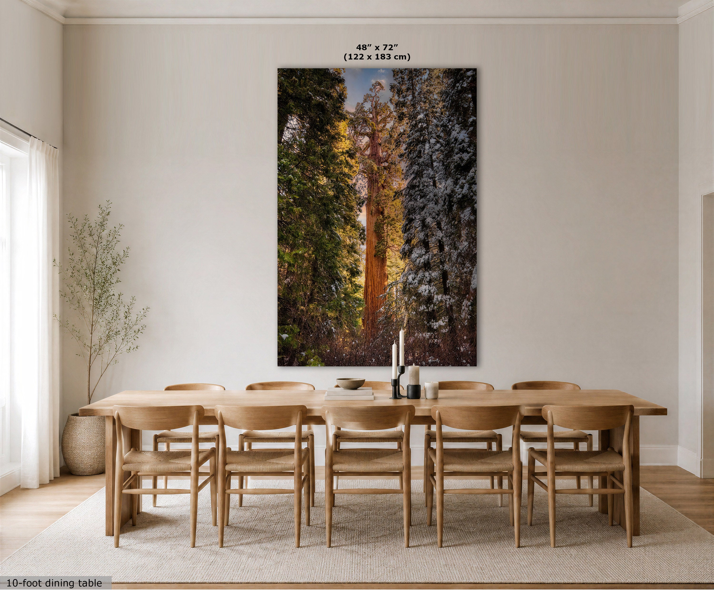 A large vertical wall art print showing a forest scene with tall trees in autumn colors, displayed above a wooden dining table and chairs in a bright, modern dining room. Text at the top indicates the print size as 48 x 72 inches (122 x 183 cm).