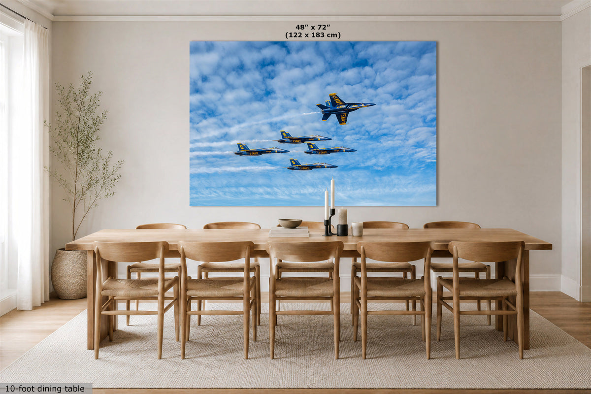 A large wall art print showing a formation of fighter jets flying through a blue sky with white clouds, displayed above a wooden dining table and chairs in a bright modern dining room. The print includes size text at the top reading 48" x 72" (122 x 183 cm).