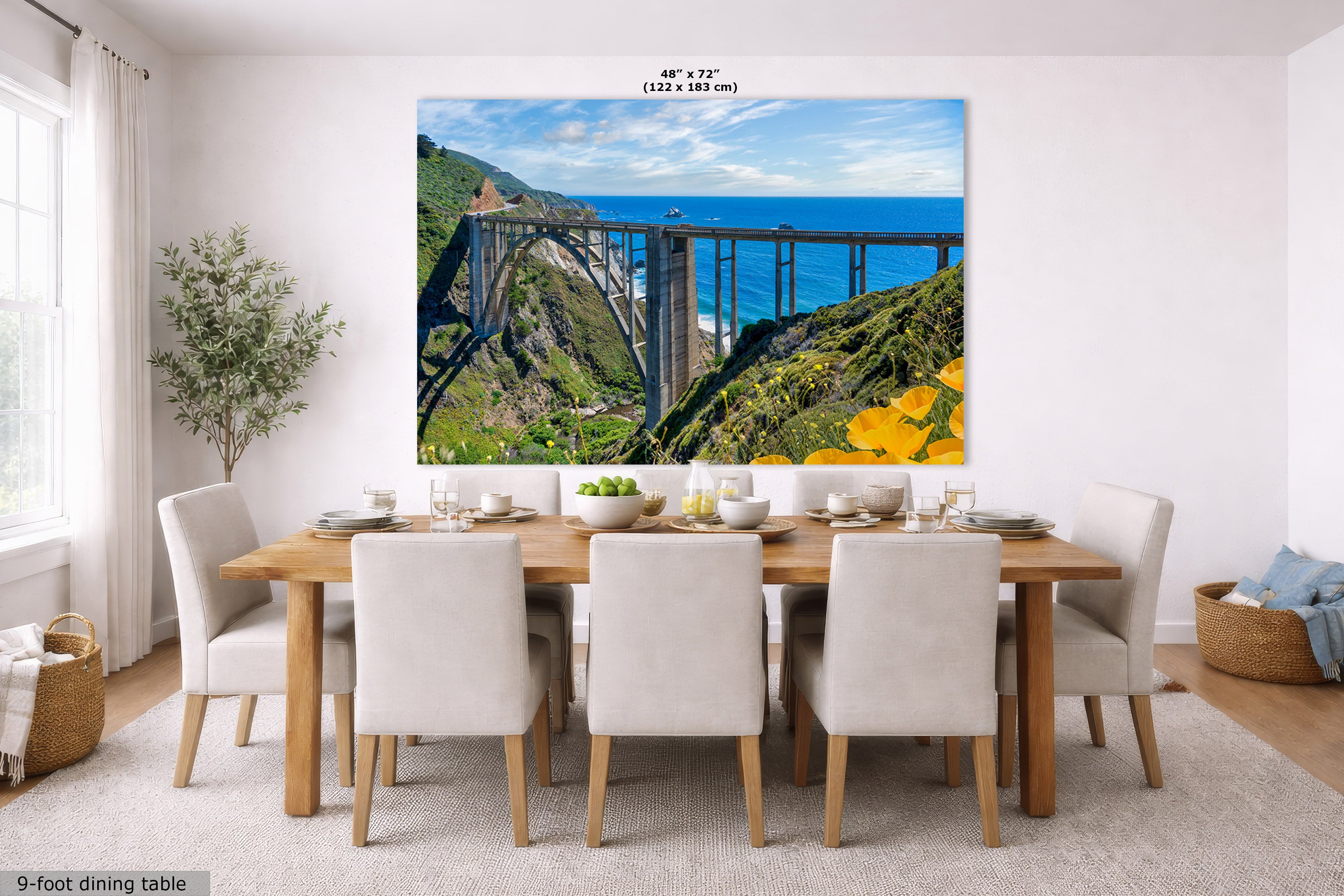 Dining room with a large wall art of a scenic bridge and ocean view.