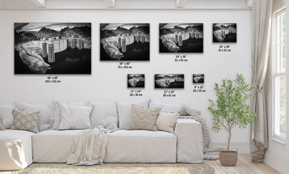 a living room with a white couch and four black and white pictures on the wall