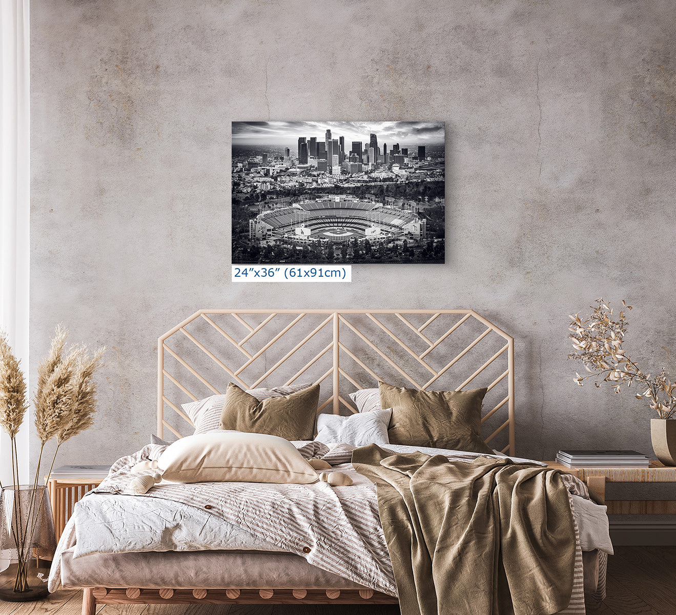 24x36 inch monochrome print of Dodger Stadium and the Los Angeles skyline above a modern bedroom with neutral textiles, black and white baseball wall art