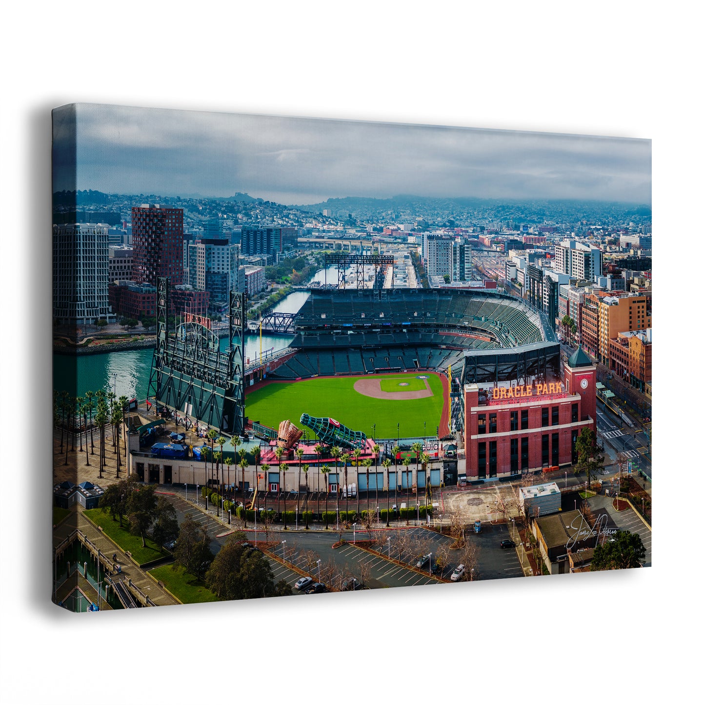 An aerial view of a baseball stadium in a city, with the surrounding buildings and cityscape visible in the background.