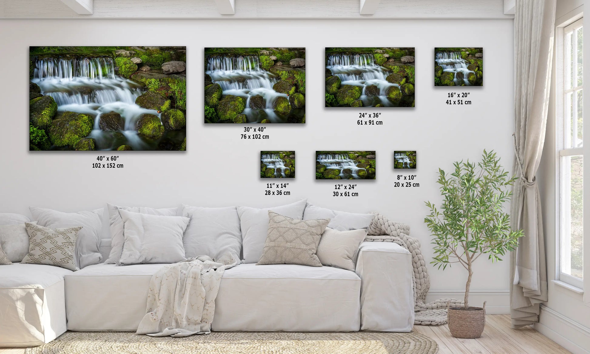 a living room with a white couch and three pictures on the wall