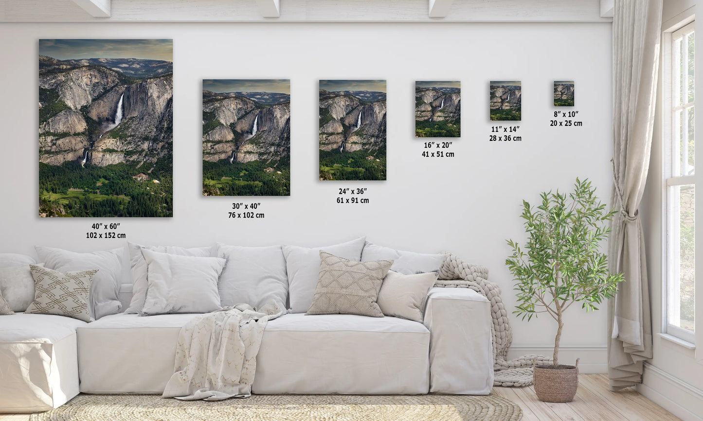 a living room with a white couch and paintings on the wall