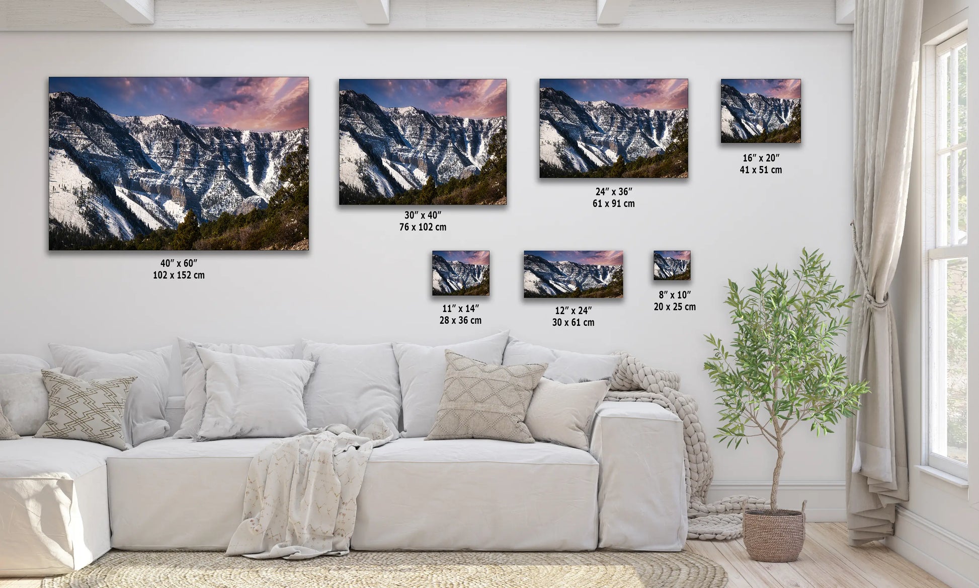 a living room with a white couch and three pictures on the wall