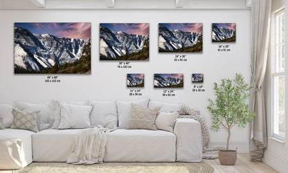 a living room with a white couch and three pictures on the wall