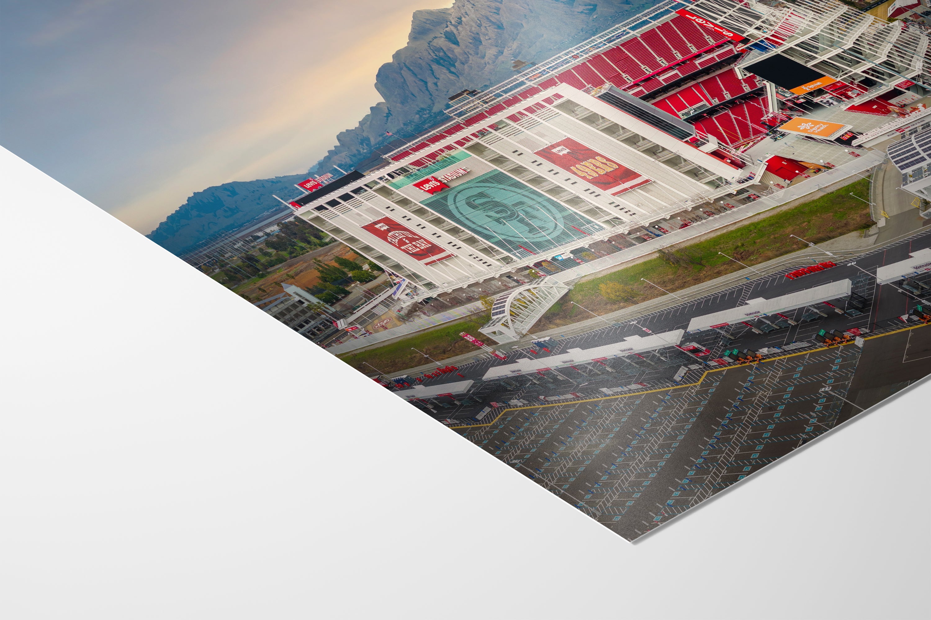 The image is a collage of various scenes, including a large stadium with a prominent logo, a parking lot, and mountains in the background.