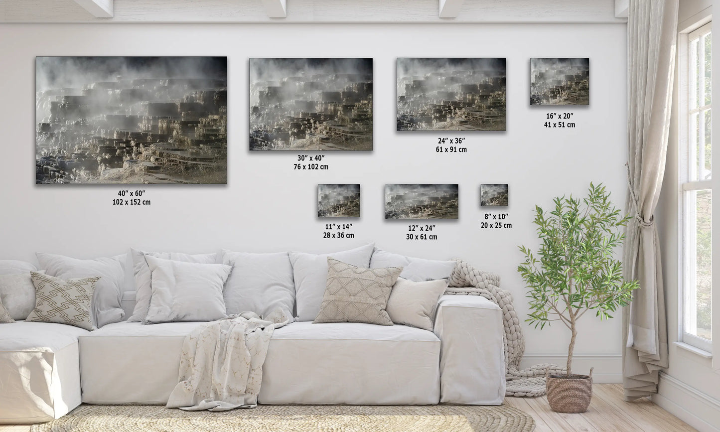 a living room with a white couch and four pictures on the wall