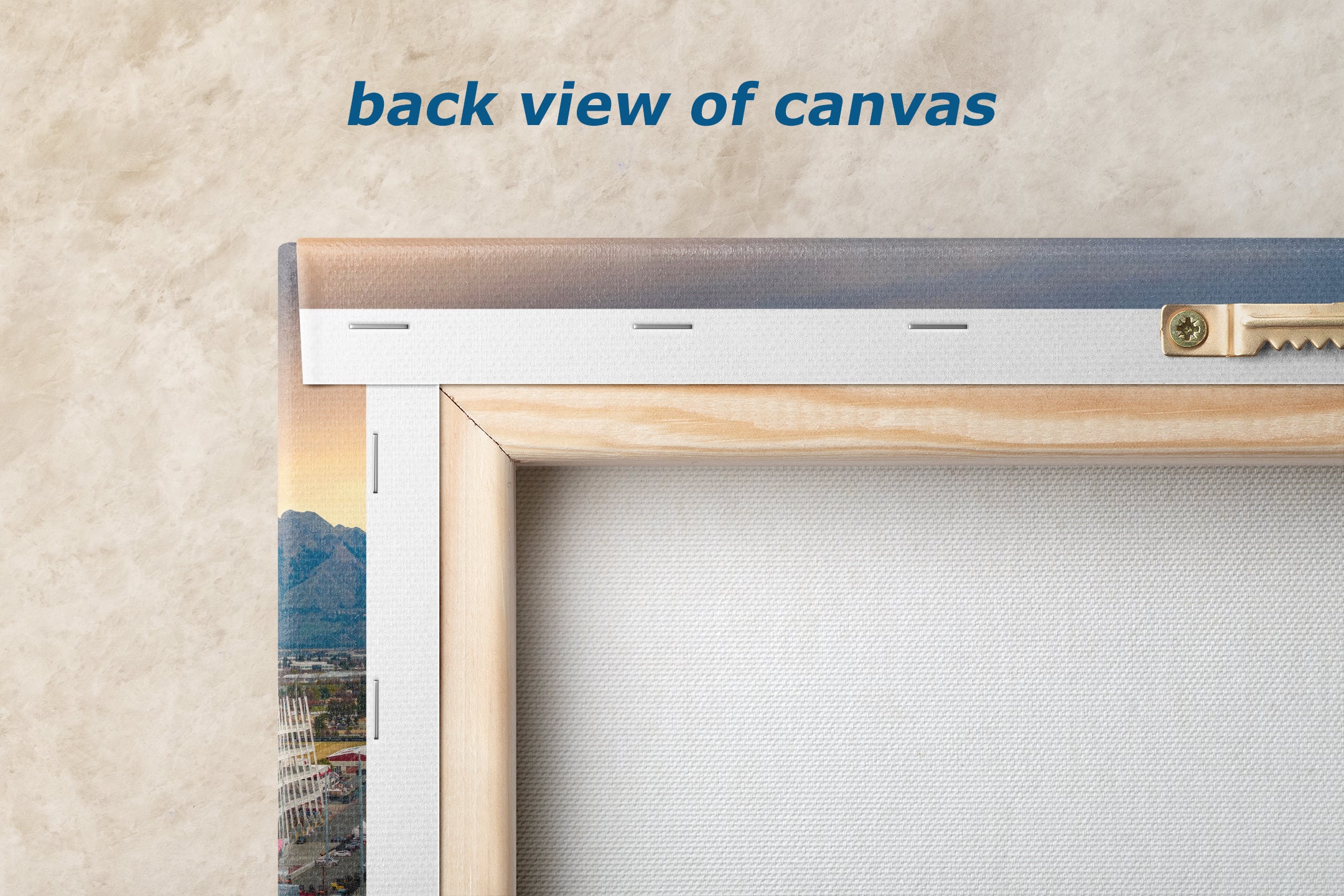 a back view of a canvas with a wooden frame, displaying a cityscape on the canvas.