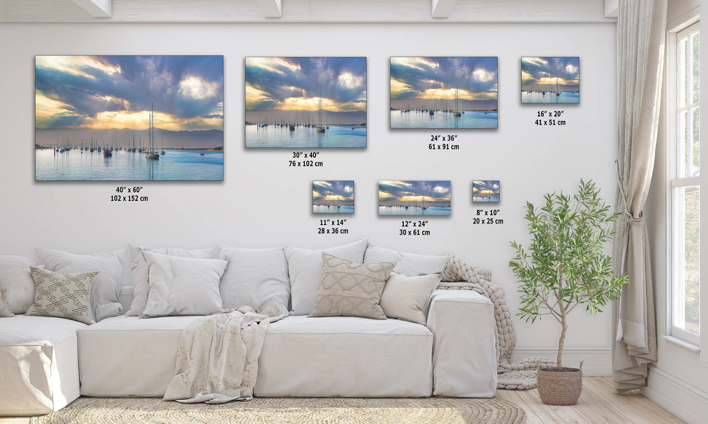 a living room with a white couch and paintings on the wall