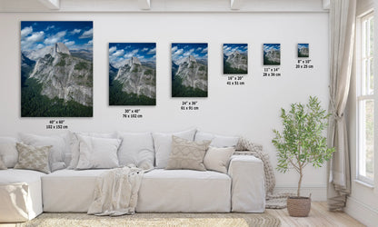 a living room with a white couch and three pictures on the wall