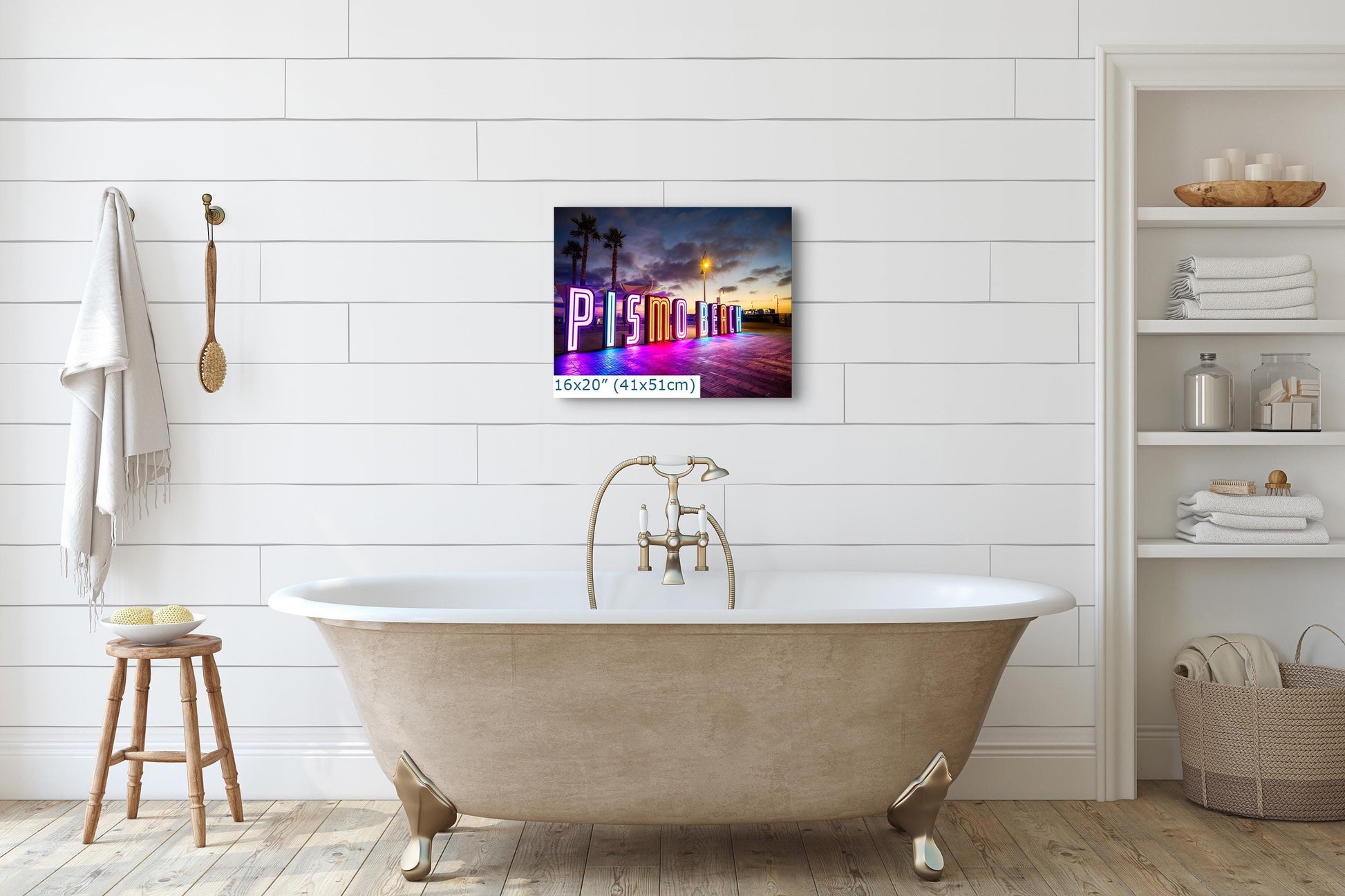 A 16x20 canvas print of the Pismo Beach neon sign displayed in a stylish bathroom, complementing the modern decor.