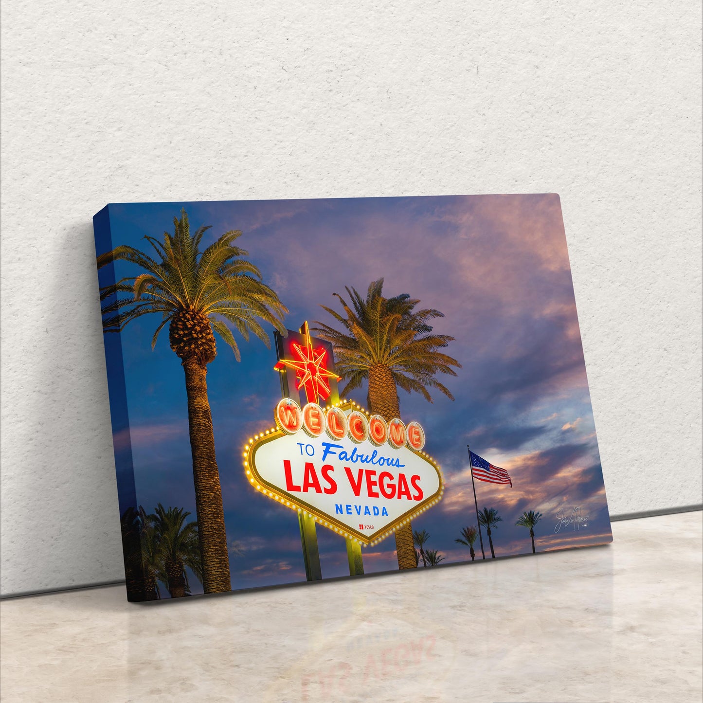 a las vegas sign with palm trees in the background