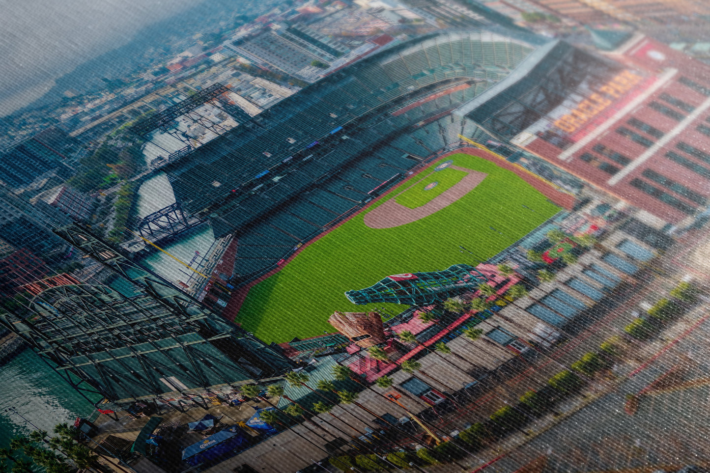 The image is an aerial view of a baseball stadium, showcasing the field, seating areas, and surrounding buildings.
