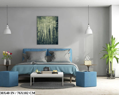 A large 30x40-inch canvas print dominating the wall above a blue bed, featuring a duotone photograph of aspen birch trees, adding a spectral touch to the bedroom.