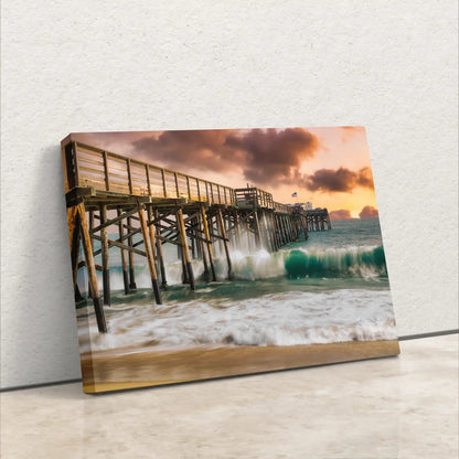 A canvas print of Balboa Pier at sunset, leaning against a wall, showcasing the wave texture and sunset hues.