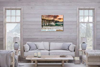 A 30x40 inch canvas wall art of Balboa Pier at sunset, centered over a sofa in a cozy living room.