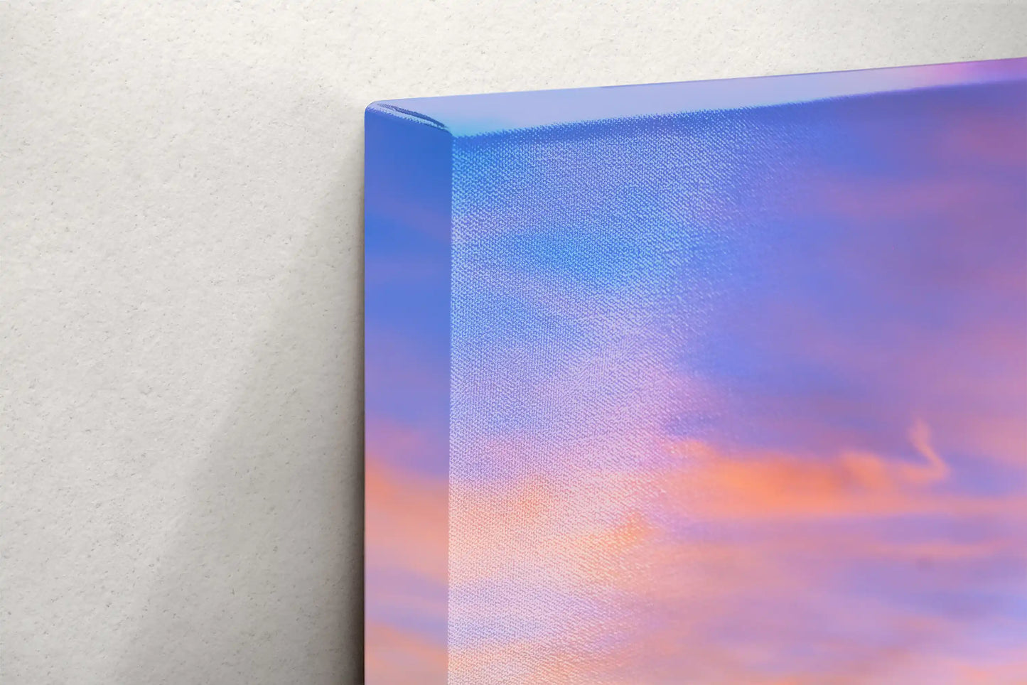 Edge of a canvas print showing a smooth transition of a Big Sur sunset with vibrant purple and orange hues.