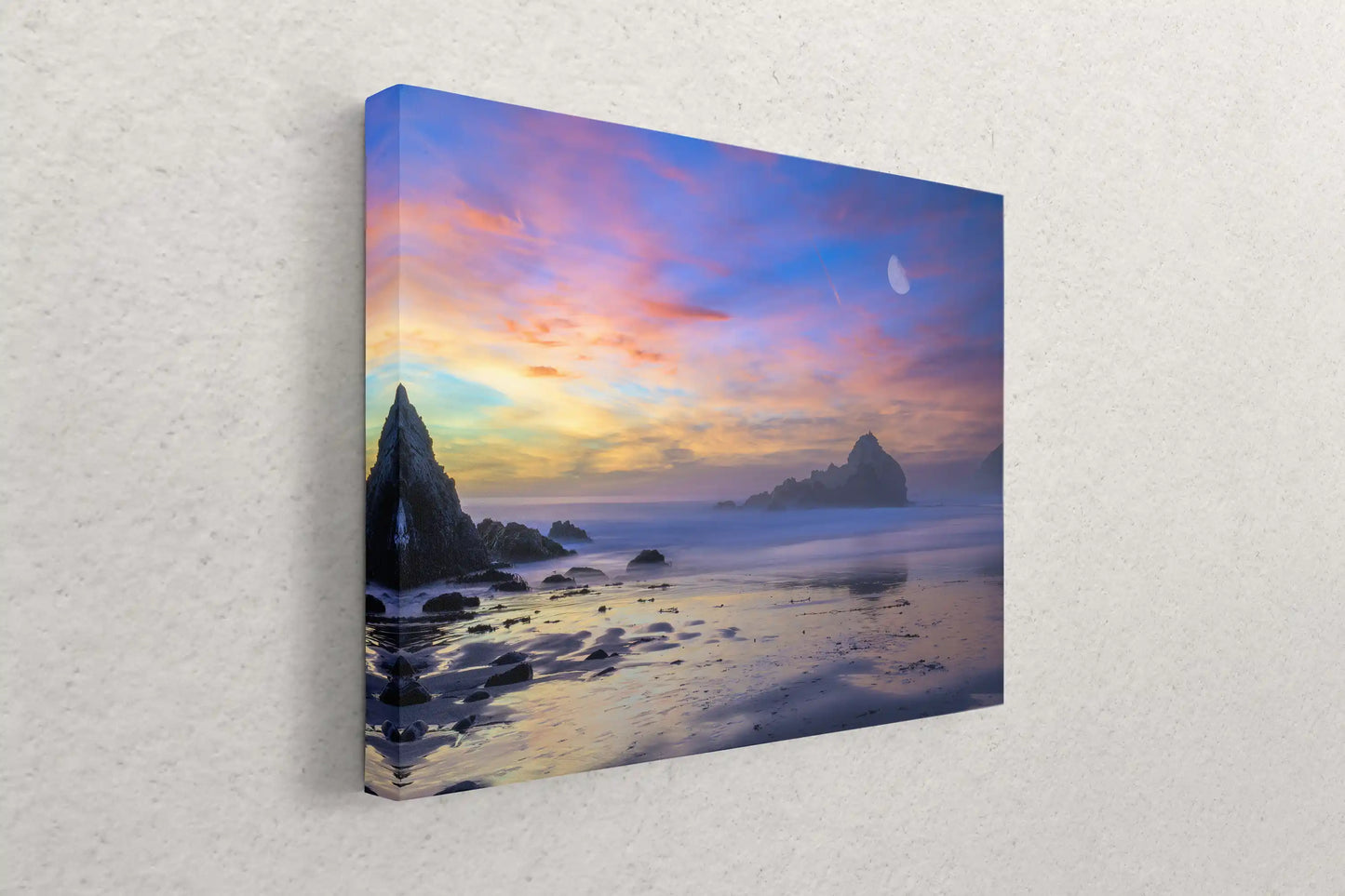 Side view of a canvas print on a wall, depicting a tranquil Big Sur sunset with moonrise, embodying calm and beauty.