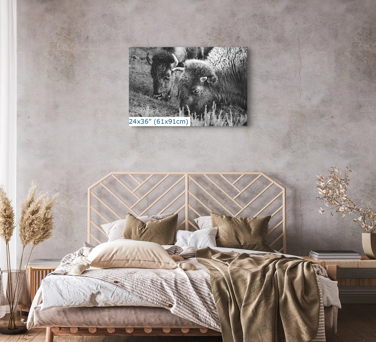 A 24x36 canvas print of a black and white bison photograph above a bed, creating a natural and calm bedroom setting.