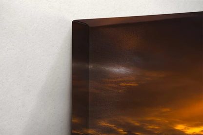 Edge detail of a canvas print depicting Hobson Beach at sunset, the golden light reflects off the textured surface, enhancing the artwork’s depth.