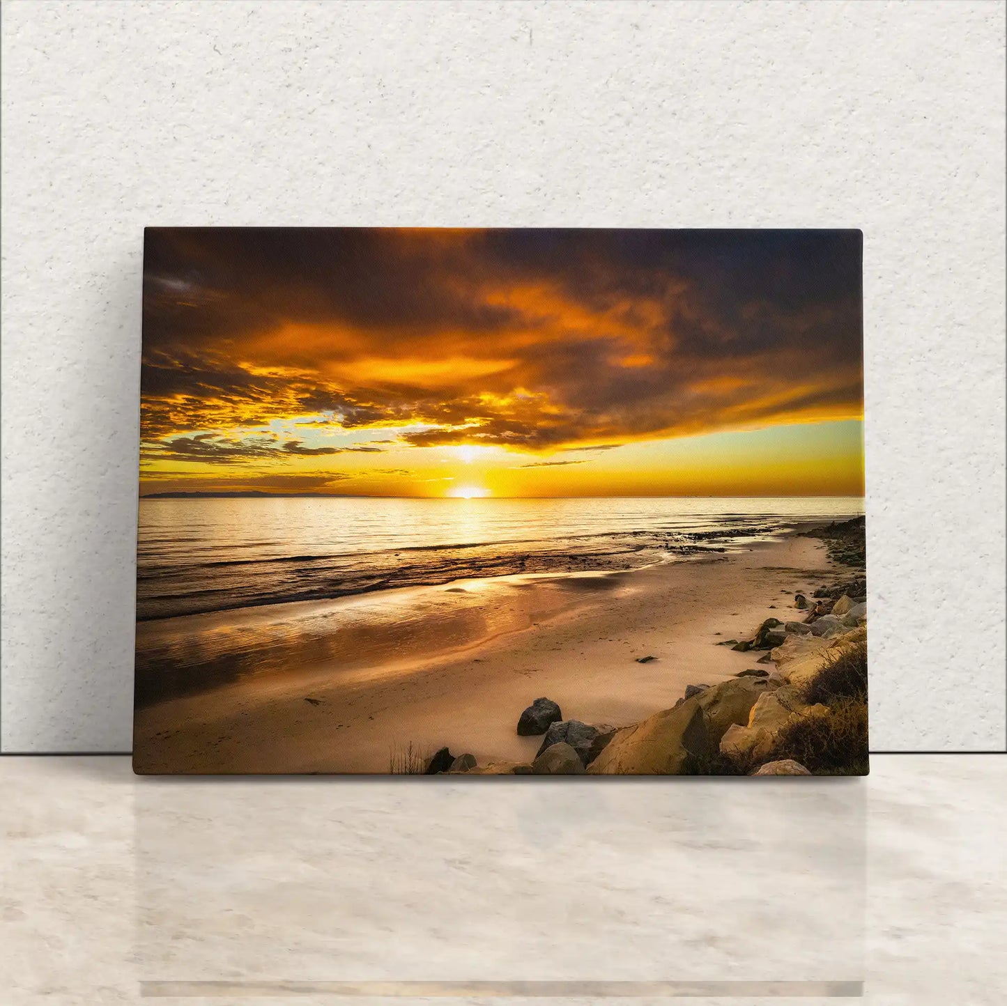 Canvas print leaning against a wall, capturing the majestic sunset at Hobson Beach, with radiant skies and a tranquil sea, inviting a sense of calm.