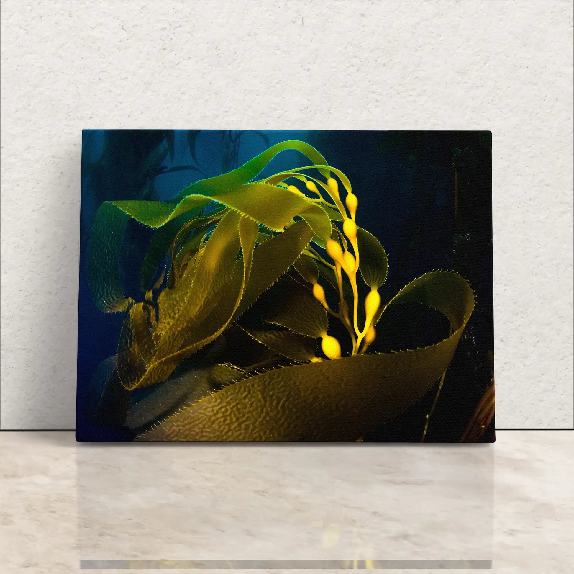 Canvas wall art of an underwater kelp forest with vibrant yellow and green kelp leaves against a dark blue sea.