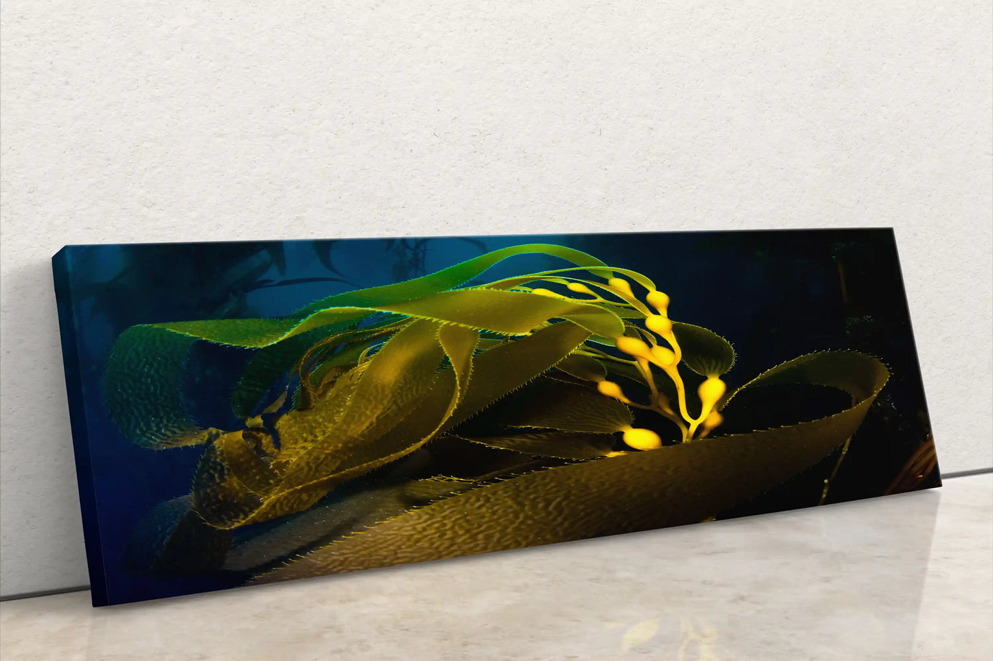Panoramic canvas wall art of an underwater kelp forest with vibrant yellow and green kelp leaves against a dark blue sea.