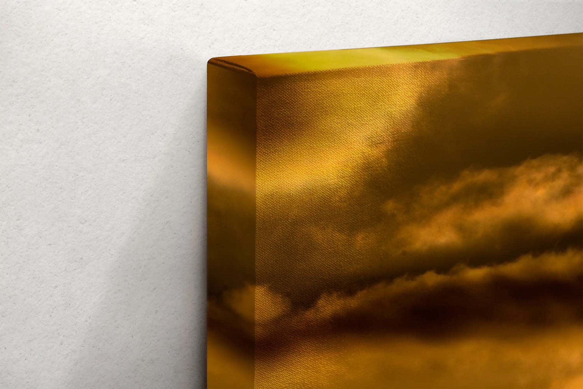 Close-up of the corner of a canvas print, displaying the sturdy frame and mounting hardware of a California sunset art piece.