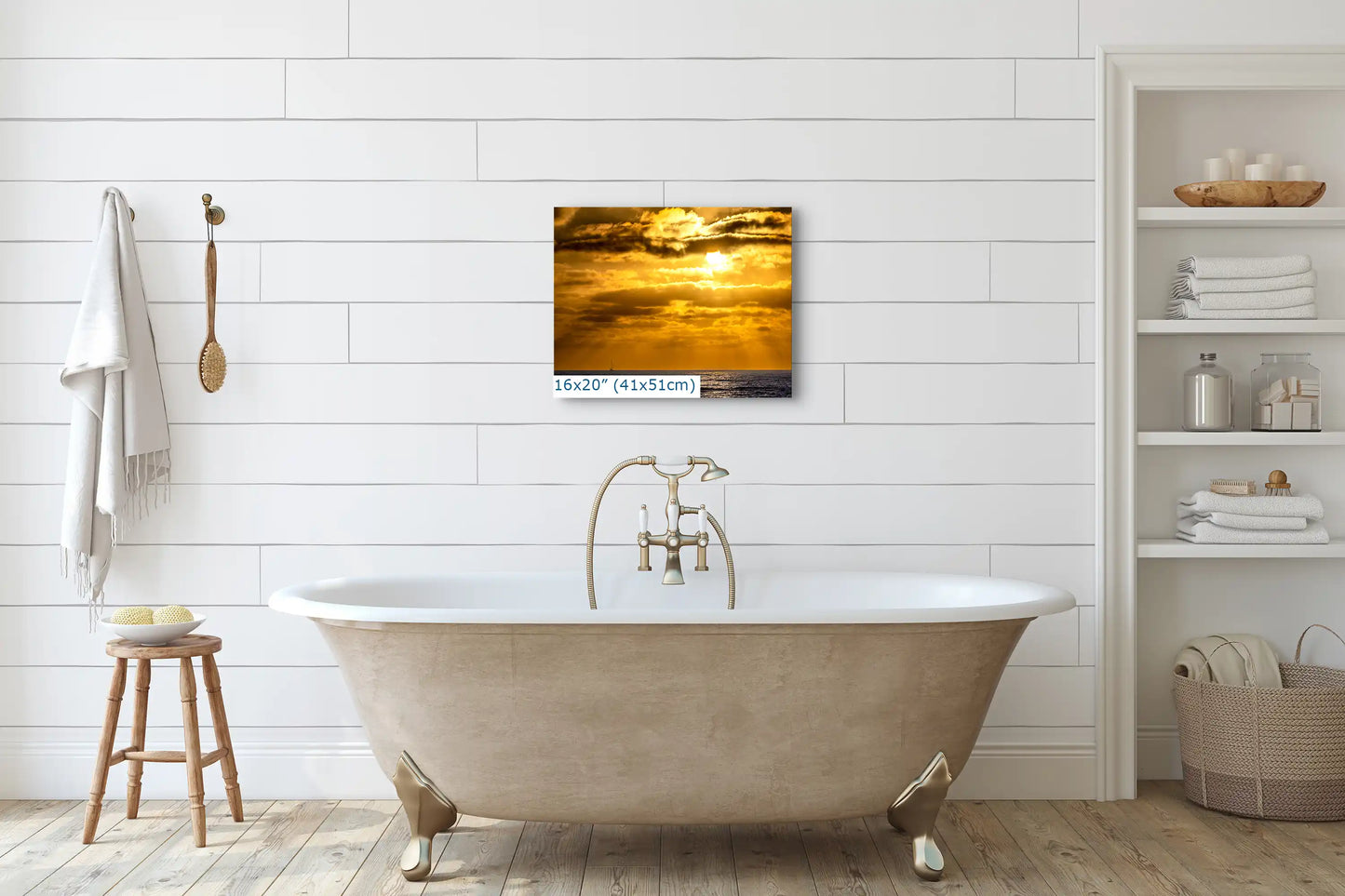 A 16"x20" canvas print of a California sunset above a bathtub, adding a warm, serene ambiance to a white bathroom.