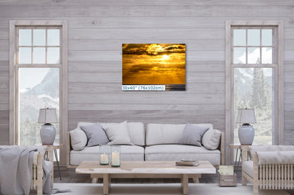 A large 30"x40" canvas print of a California sunset in a living room setting, serving as a dramatic and eye-catching wall feature.