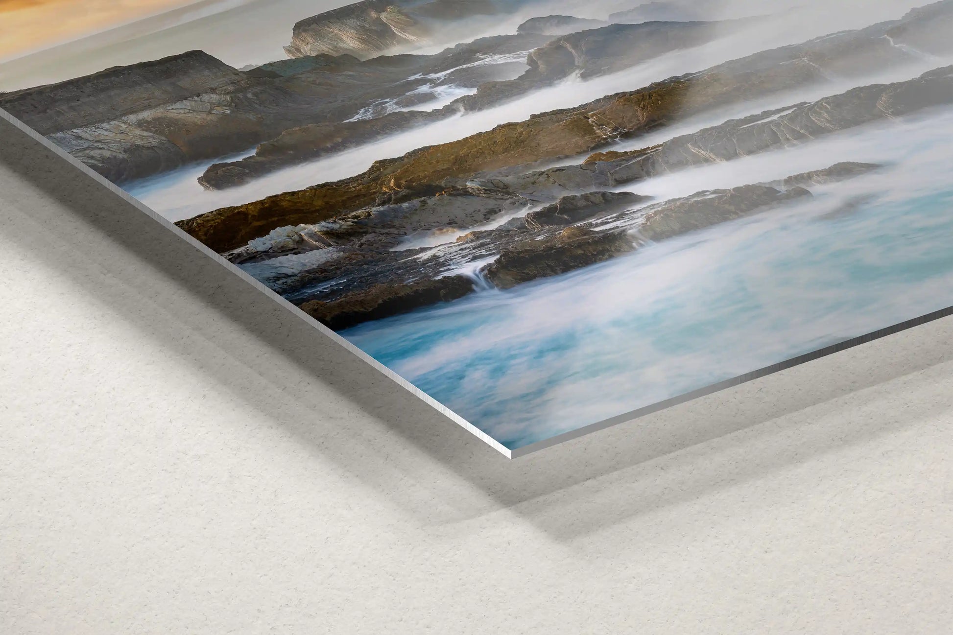 Detailed shot of a metal print corner, featuring the rugged beauty of the California Pacific coastline, combining modern style with natural grace.