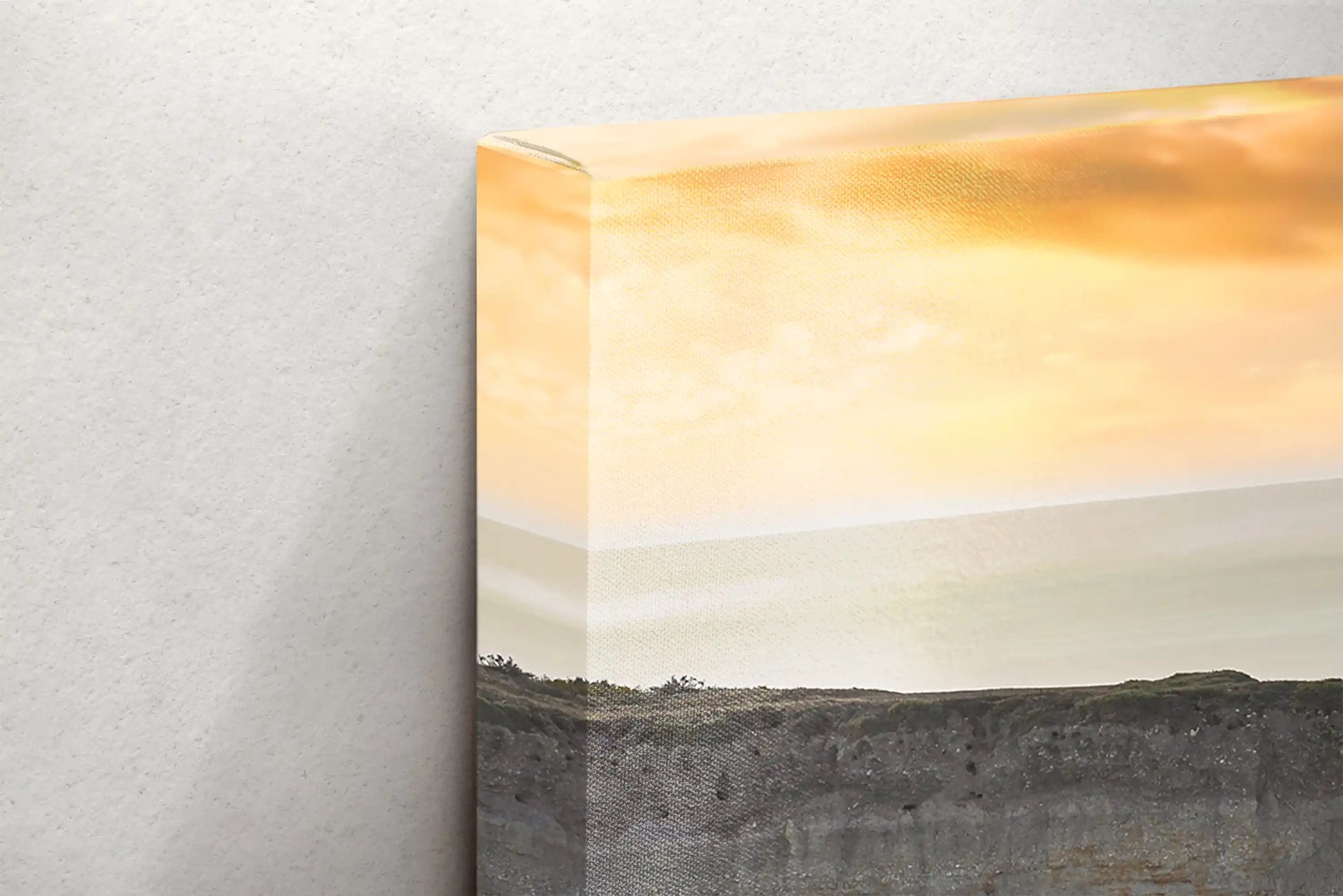 Detail of a canvas edge with a golden sky over the California Pacific cliffs at dusk, highlighting the seamless gallery wrap finish.
